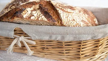 Crusty bread in a woven basket.