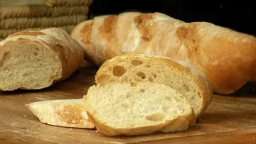 Geschnittenes Baguette auf Holzbrett.