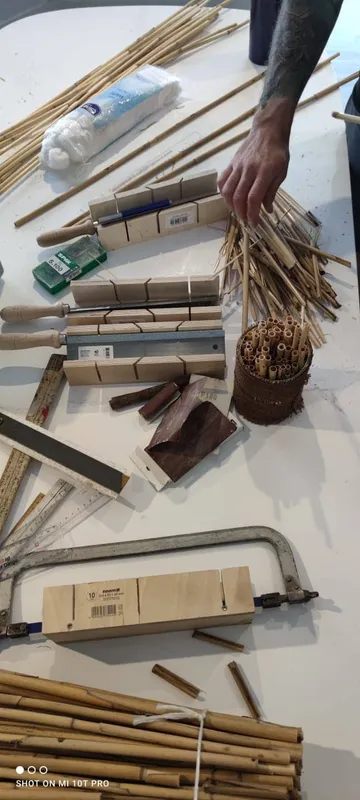 Woodworking tools and materials on workbench.