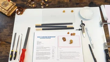 Wax carving tools on workshop table.