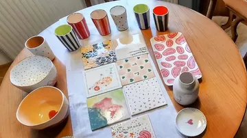 Decorative plates and cups on wooden table.