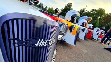 Hot Rod cars lined up on street.