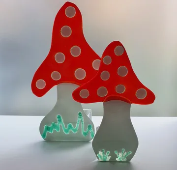 Glass mushroom sculptures with red tops.