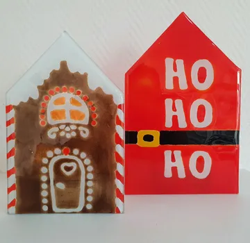 Two decorated Christmas-themed glass houses.