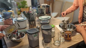 People preparing ingredients in a kitchen.