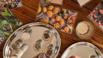 Small jars on trays with fruit photos.