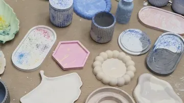 Assorted colorful resin molds on a table.