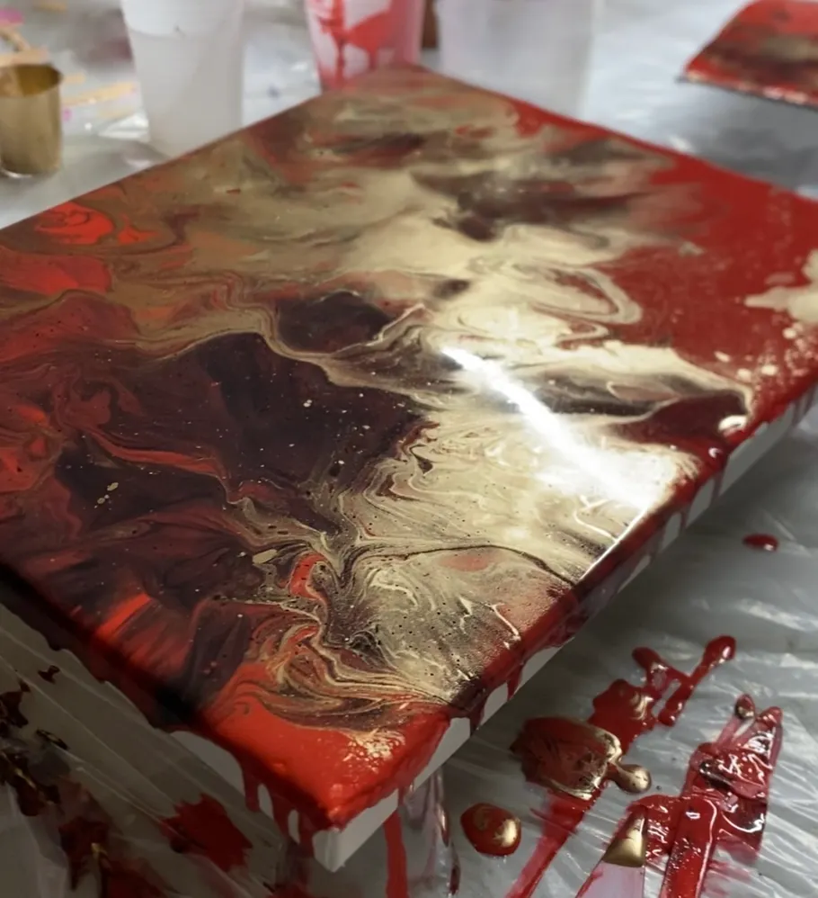 Abstract painting with red, gold, and brown swirls.