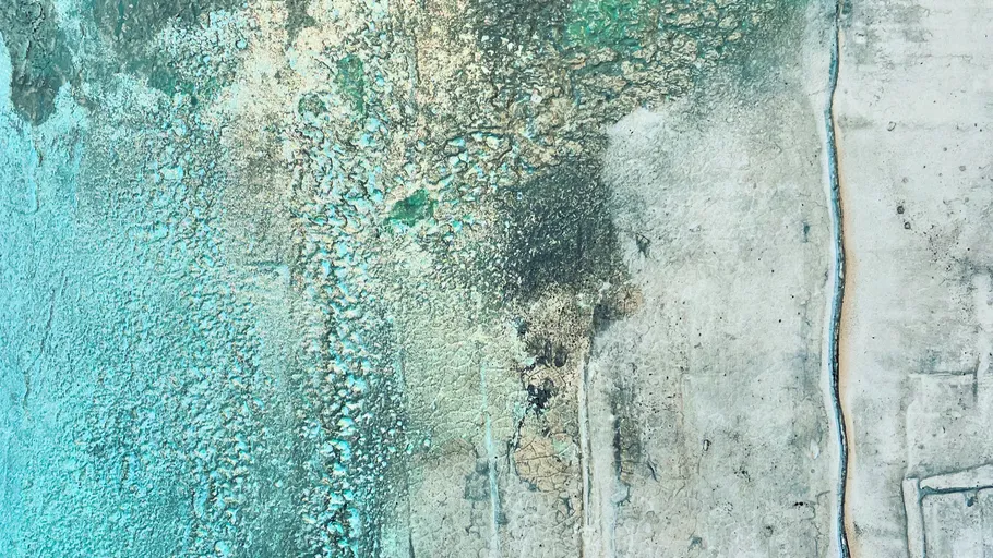 Abstract textured surface in blue and beige tones.