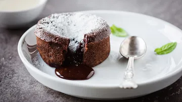 Molten chocolate cake on a white plate.