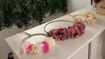 Three floral wreaths on display table.
