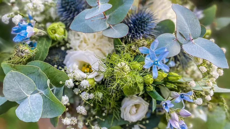 Colourful flowers and leaves put together in an arrangement.