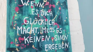 Colorful painting with German motivational text.