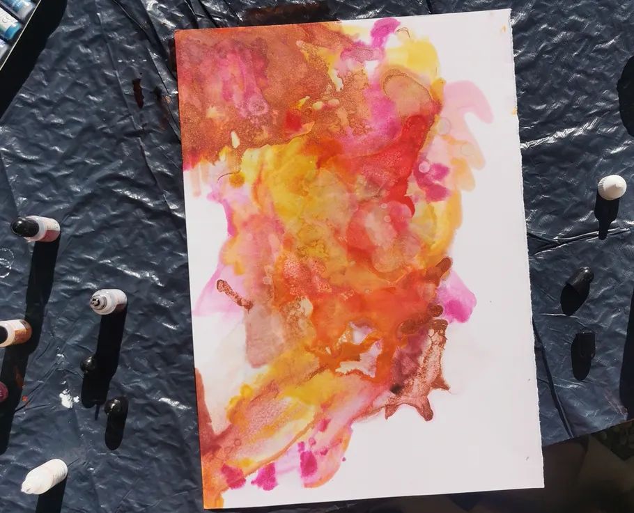 Abstract watercolor painting on textured surface.