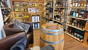 Liquor store interior with wooden shelves.