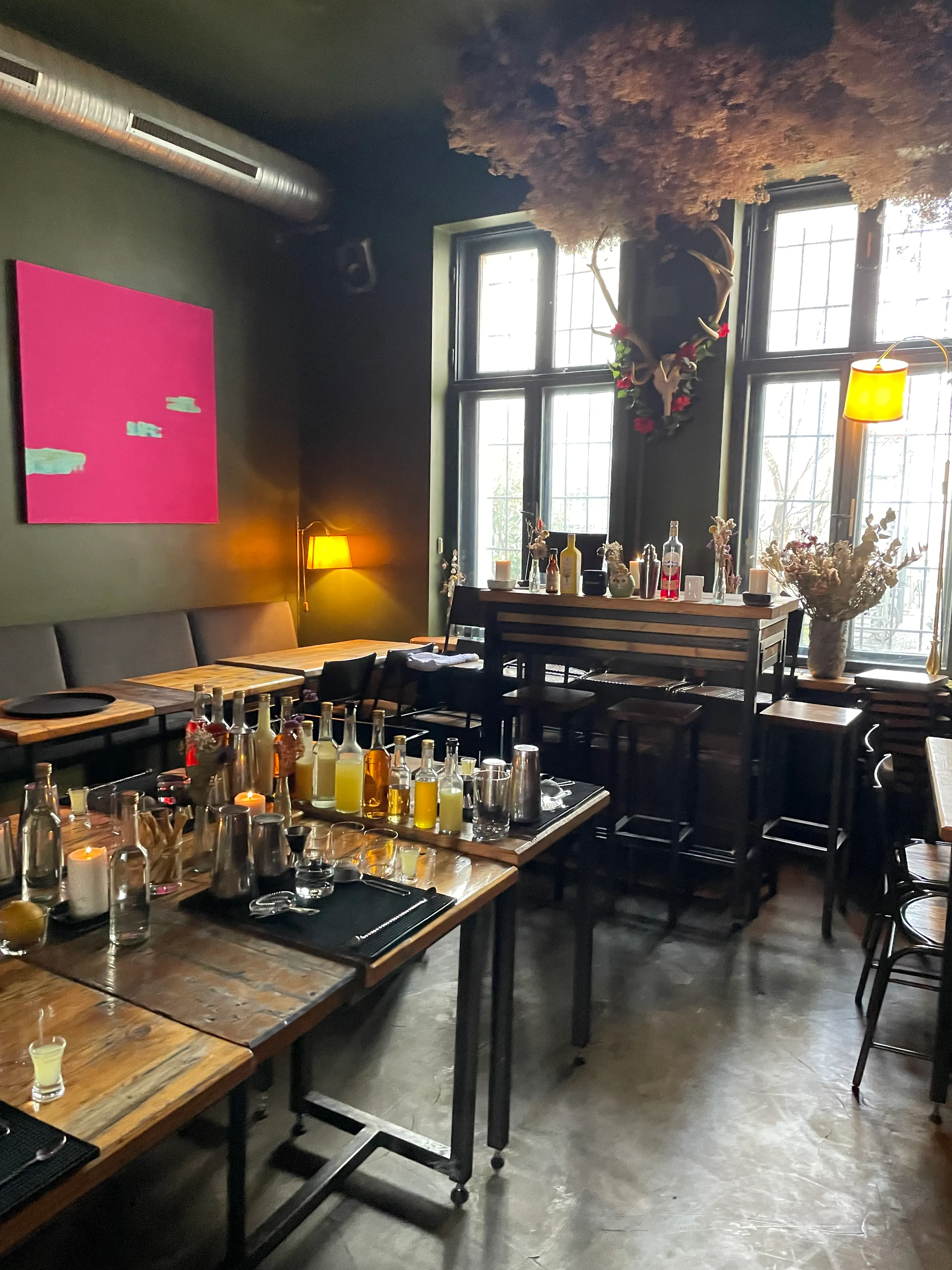 Bar counter with drinks in modern, cozy interior.
