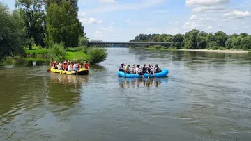 People rafting on a calm river scene.
