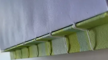 Close-up of book with hand-stitched binding.