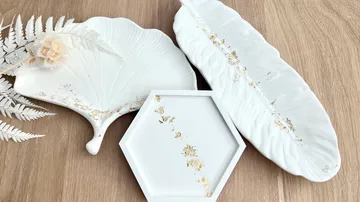 White decorative plates on wooden surface.