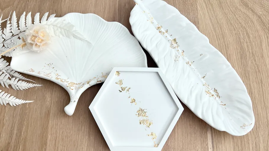 White decorative plates on wooden surface.