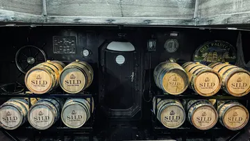 Barrels labeled SILD inside a ship's cabin.