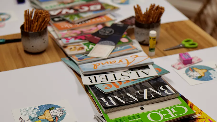 Magazines stacked on a wooden table.