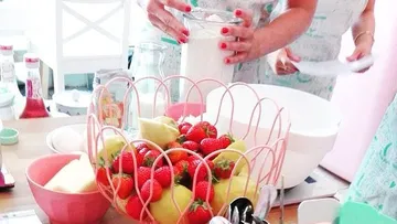 People preparing ingredients in a kitchen.
