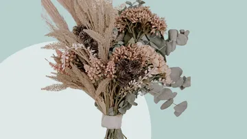 Dried floral bouquet on a light blue background.