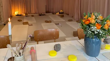 Yoga mats, blocks, and pottery materials in studio.
