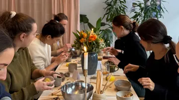 People crafting with clay at a table.