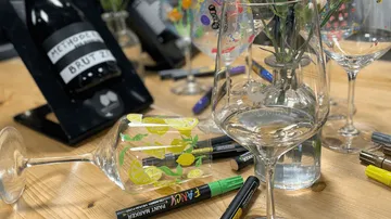 Decorated wine glasses on wooden table.