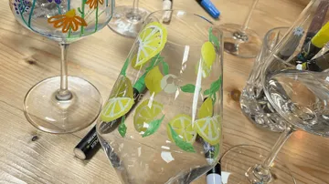 Painted wine glasses with lemon and flower designs.