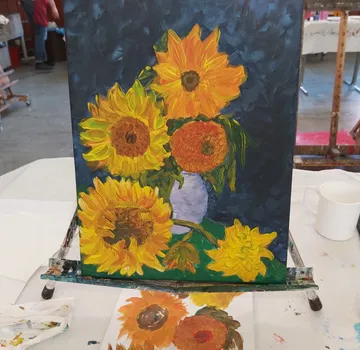 Sunflower painting on easel in studio.