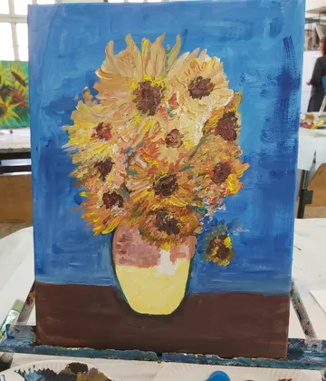 Sunflowers in a vase on a table.