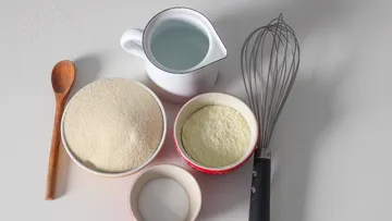 Baking ingredients with whisk on countertop.