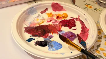 Paint palette with various colors and brush.
