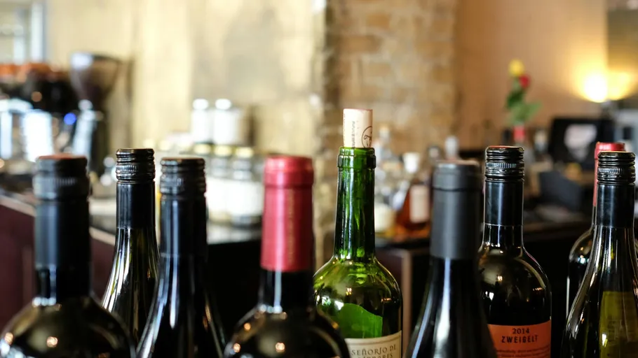Assorted wine bottles on a bar counter.