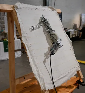 Mechanical device working on textile at fair.