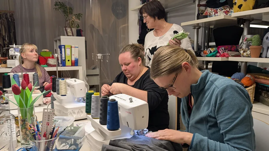 Women sewing in a fabric workshop.