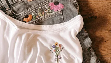 Embroidered flowers on jeans and white shirt.