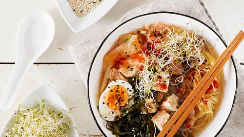 Bowl of ramen with vegetables and egg.
