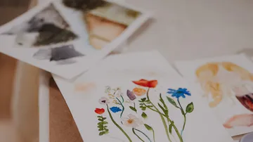 Watercolor paintings on a table surface.
