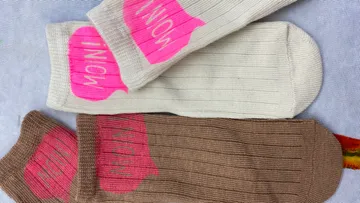 Two pairs of socks with text on them.