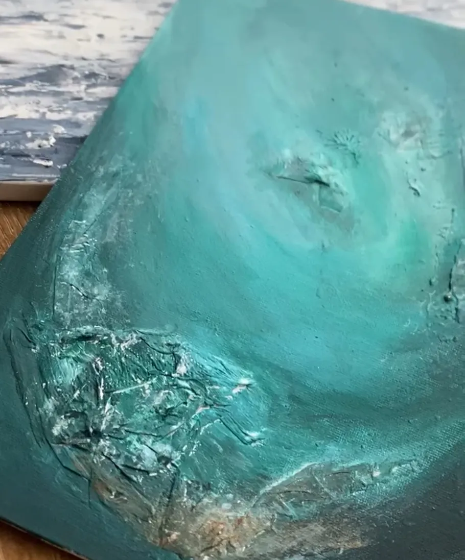 Green textured painting with abstract details.