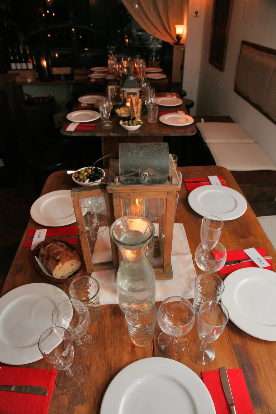 Table set with plates, glasses, and candle lantern.