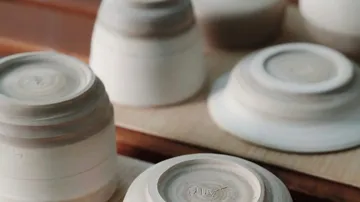 Upside-down clay bowls on a wooden surface.