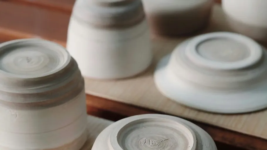 Upside-down clay bowls on a wooden surface.