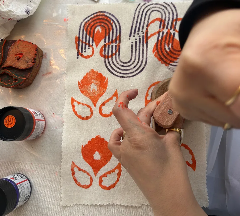 Hand stamping fabric with colorful patterns.