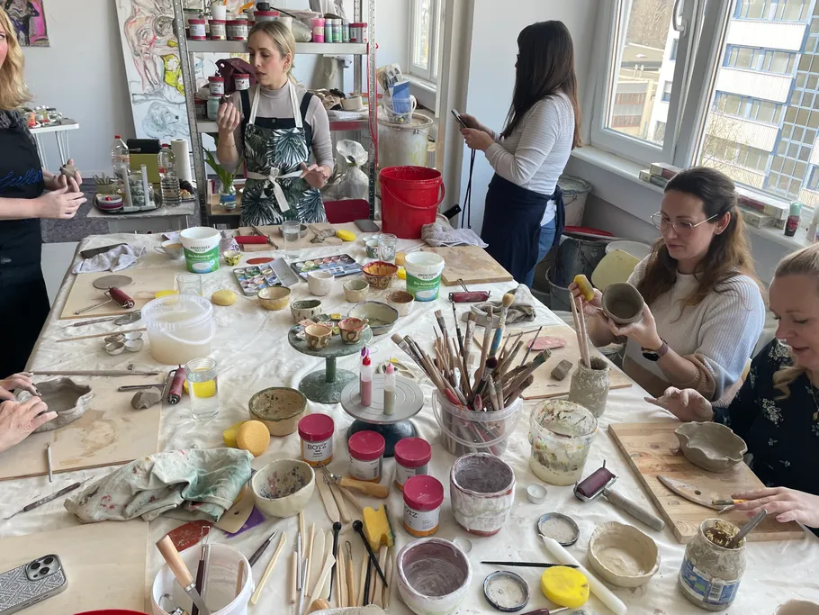 People making pottery in a craft studio.