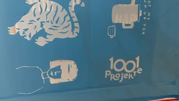 White designs on blue surface, including a tiger.